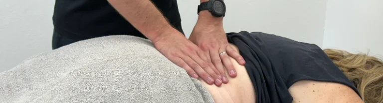 physiotherapist treating mid back pain